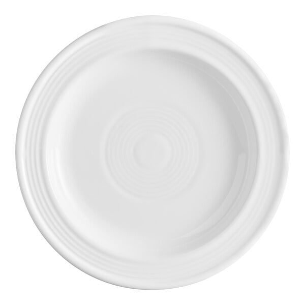 A white stoneware plate with a slightly raised rim and subtle concentric circle design.