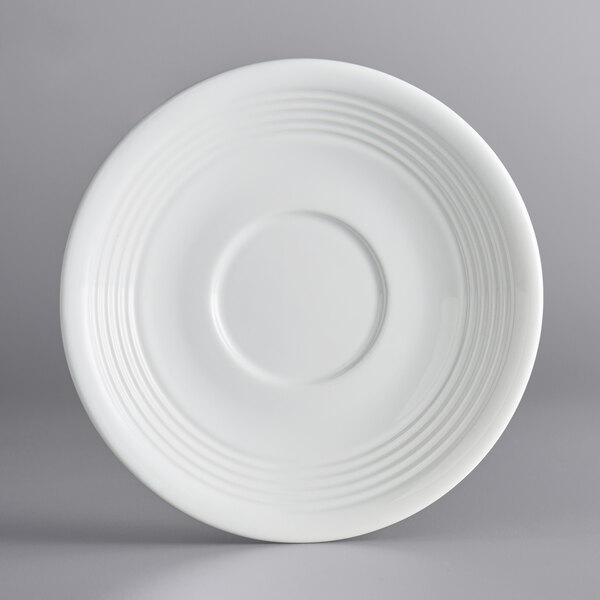 An Acopa Capri Coconut White stoneware saucer with a rim and circular design.