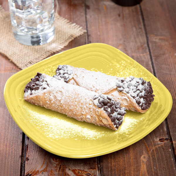 A Fiesta square china salad plate with two pastries on it.