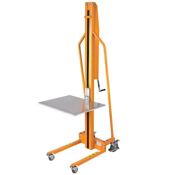 A yellow Wesco manual winch lift with a metal table on it.