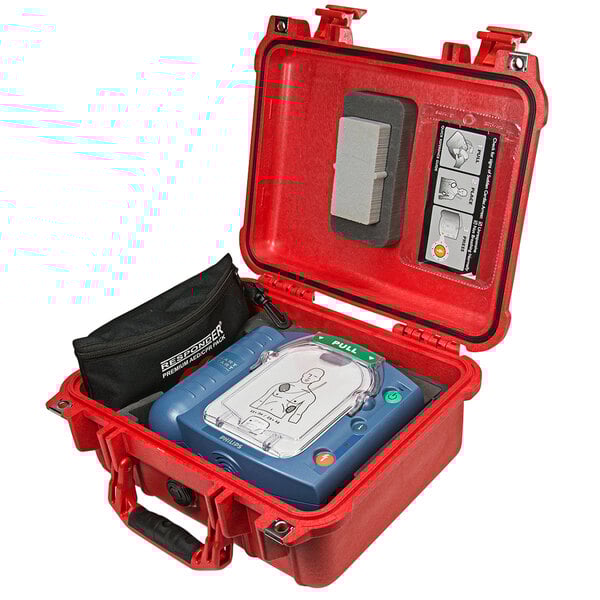 A red Philips watertight hard case with a defibrillator inside.
