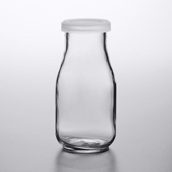 a clear glass bottle with a black cap