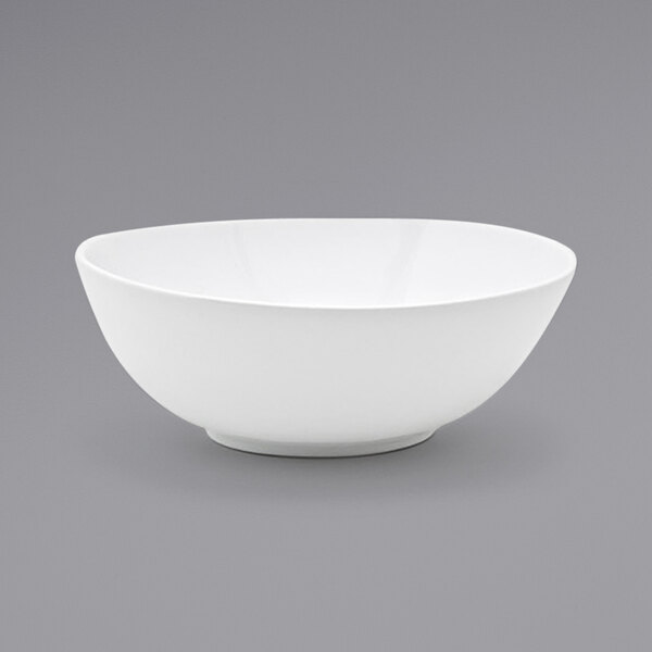 A white oval porcelain bowl with a small rim.