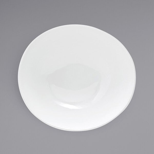 A white Front of the House Ellipse porcelain bowl on a gray surface.