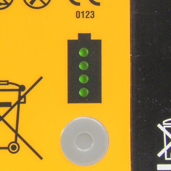 A yellow sign with a green and black symbol of a person in a white circle.