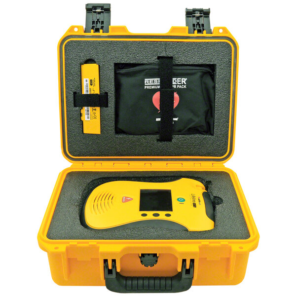 A yellow Defibtech Shok Box case with a device in it.