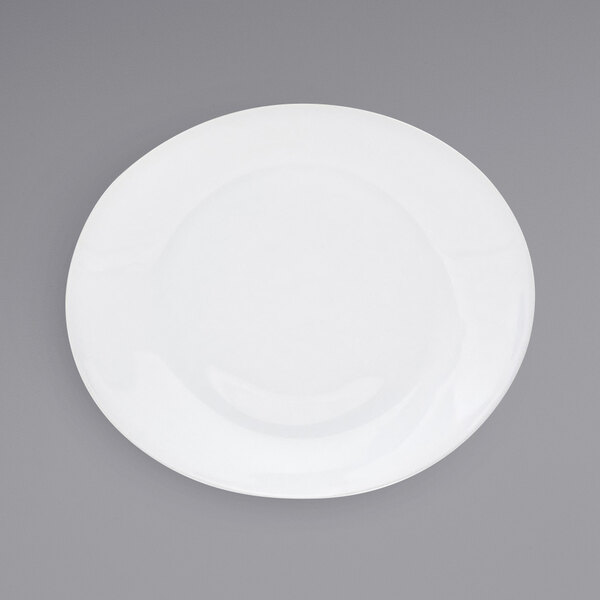 A close-up of a white Front of the House Ellipse porcelain plate with a white rim.