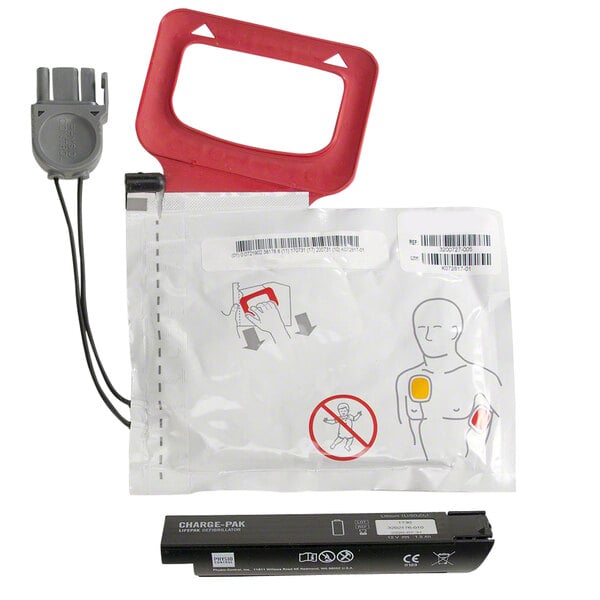 A white package with a red rectangular frame containing a black Physio-Control CHARGE-PAK charging unit.