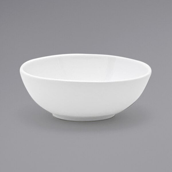 A Front of the House white oval tall porcelain bowl on a gray surface.