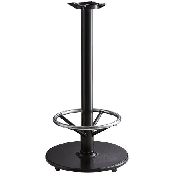 A Lancaster Table & Seating black cast iron bar height table base with a foot rest and self-leveling feet.