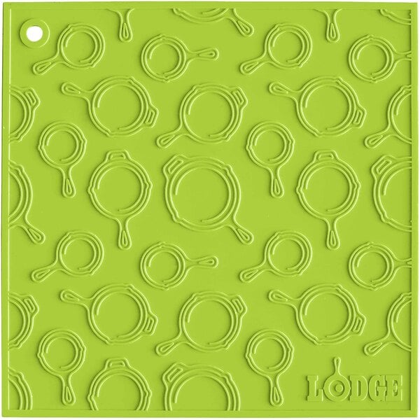 A green silicone square with a circular skillet pattern.