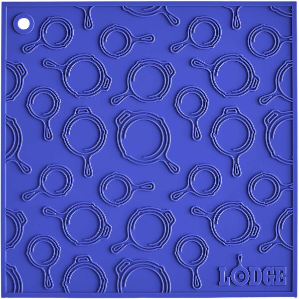 A blue square Lodge silicone trivet with a circle pattern.