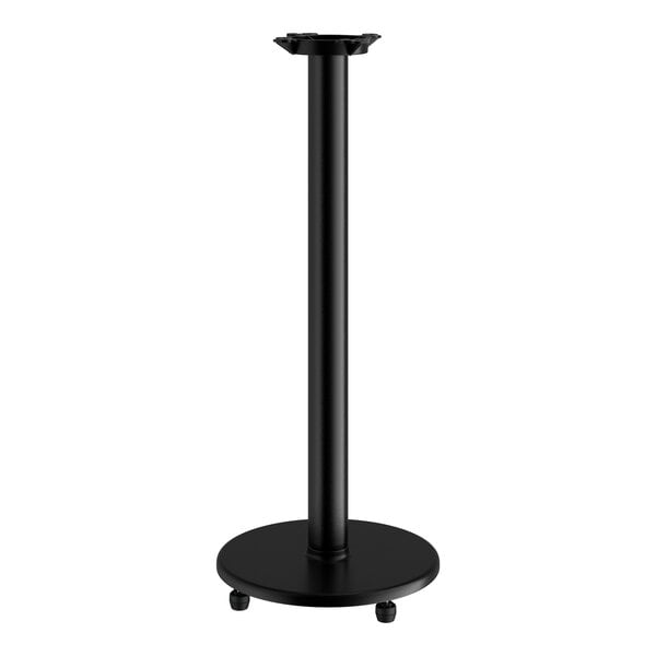 A black Lancaster Table & Seating cast iron bar height table base on a table.