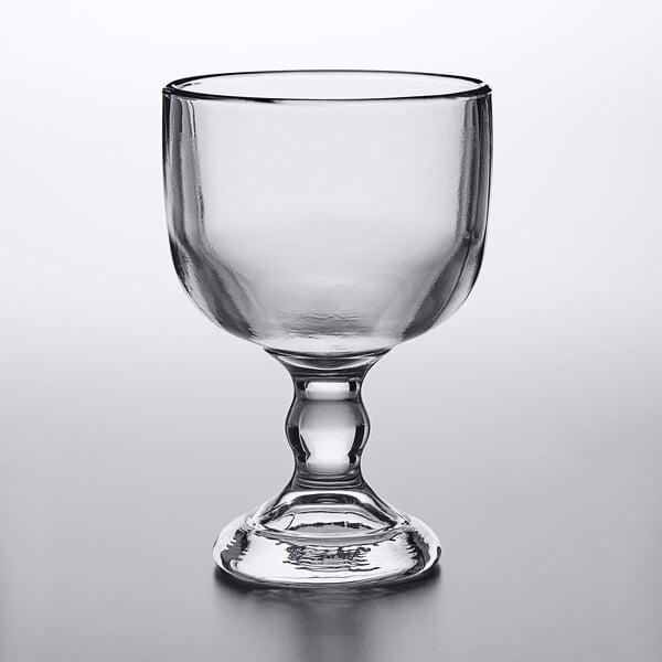 An Anchor Hocking Weiss schooner glass with a leg on a table.