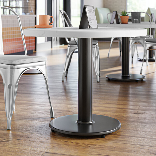 A Lancaster Table & Seating standard height table base with a black pole and spider.