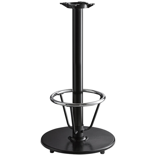 A Lancaster Table & Seating black cast iron bar height table base with a foot rest and self-leveling feet.