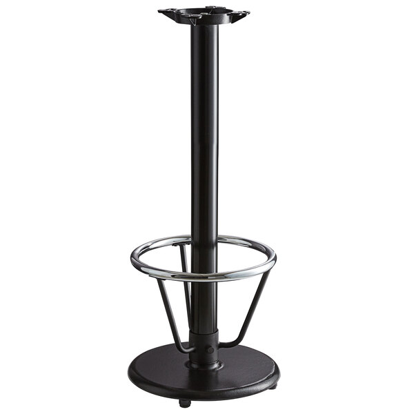 A Lancaster Table & Seating black cast iron bar height table base with a round foot rest and self-leveling feet.