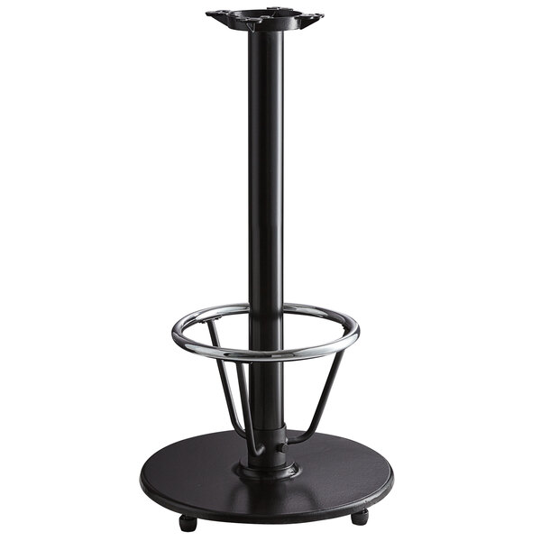 A Lancaster Table & Seating black cast iron bar height table base with a foot rest and table equalizers.