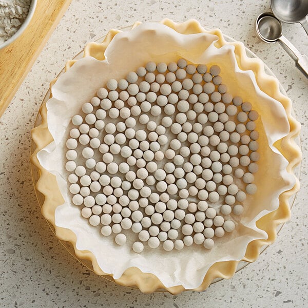 A pie crust with Fox Run ceramic pie weights in it.