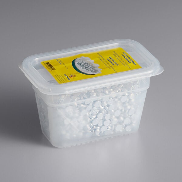A plastic container with a yellow label filled with silver aluminum pie weights.