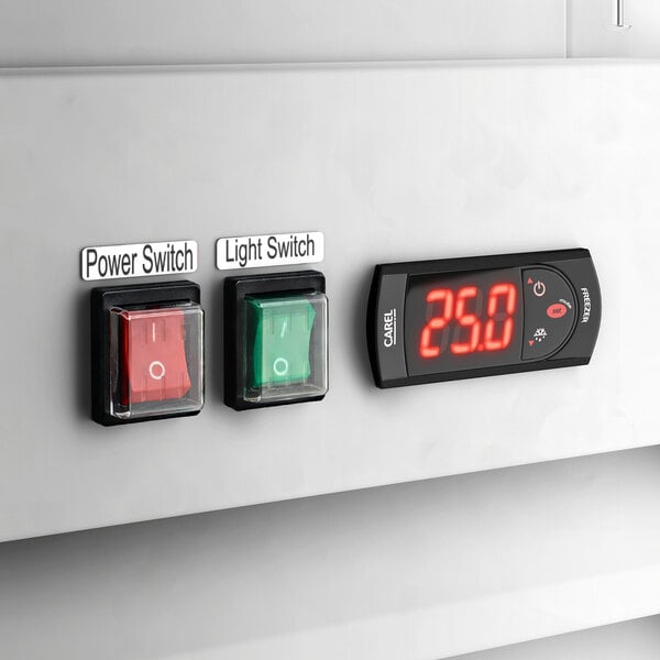 A control panel with a red power switch, a green light switch, and a digital temperature display on an Avantco GD-ICE-24F indoor glass door ice merchandiser.