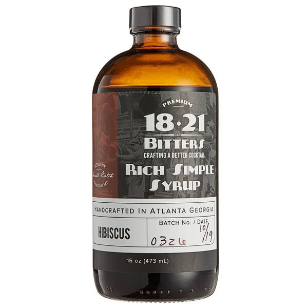 A brown 18.21 Bitters bottle with a black label.