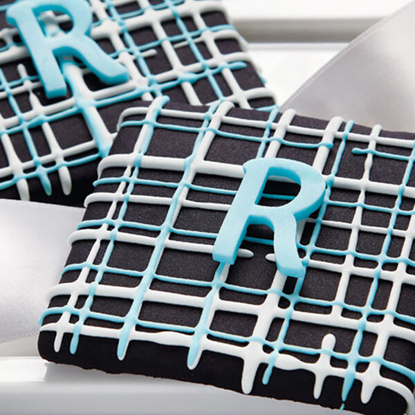 close-up of a black and white square with blue and white icing