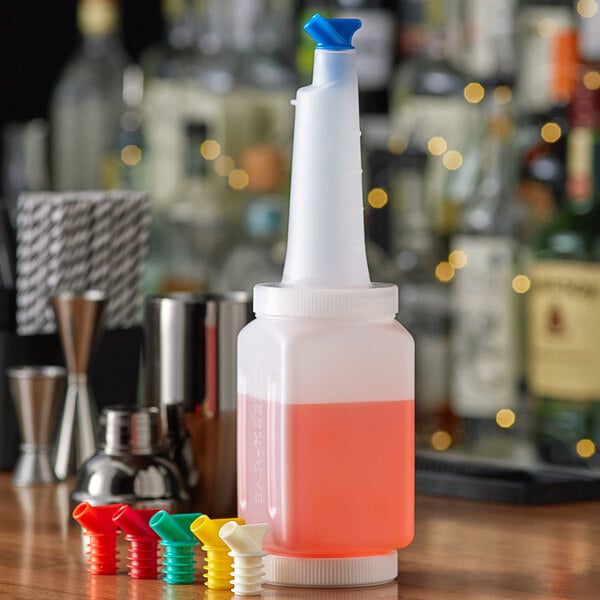 A Vollrath white pour container on a bar counter with assorted color spouts.