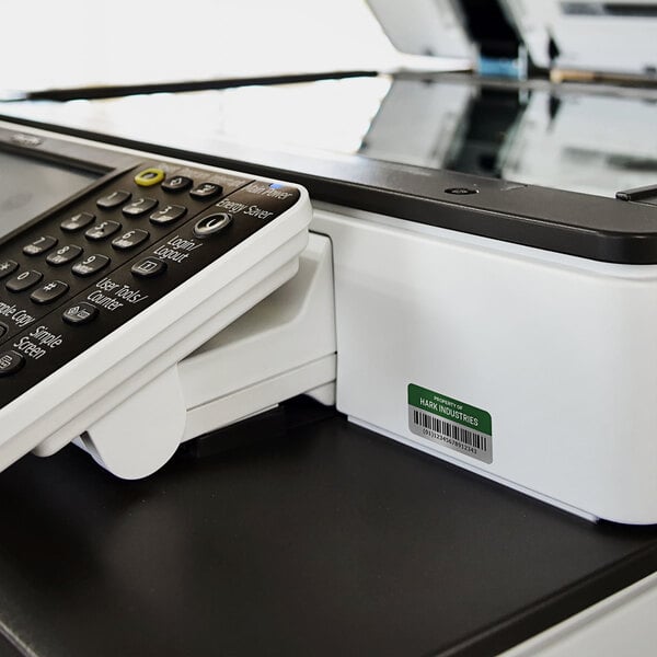 A close-up of a printer with a sheet of Avery Metallic Asset Labels being printed.