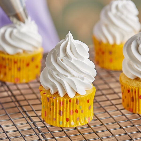 A yellow cupcake with Rich's Bettercreme vanilla whipped icing and white polka dots.