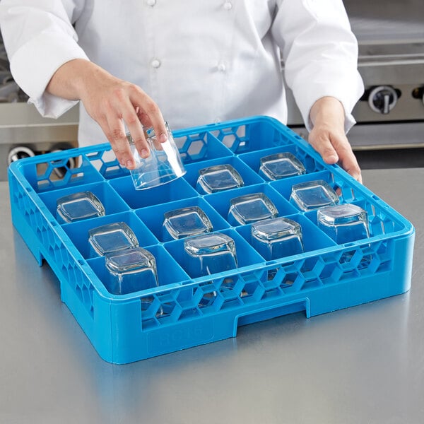 Person storing glass cups in a blue plastic cup rack