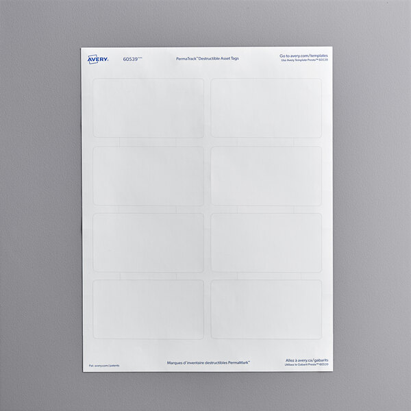 A white rectangular sheet of Avery PermaTrack destructible asset labels with blue writing and rectangles.