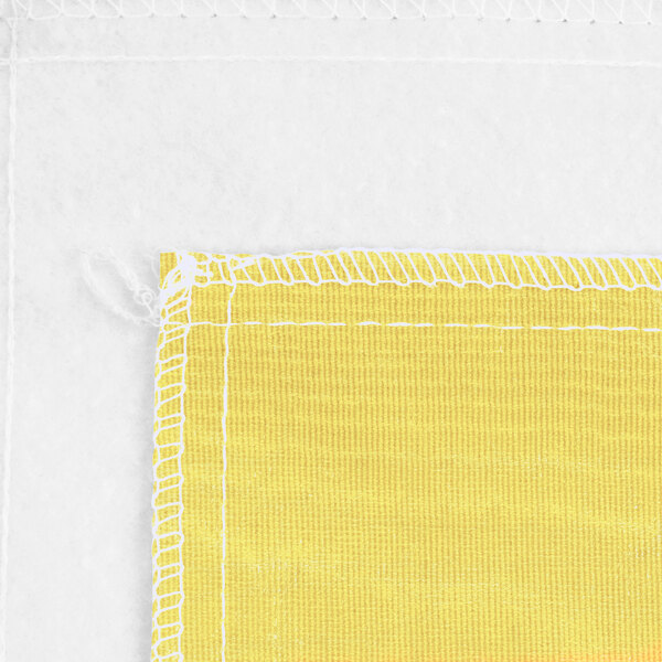 A yellow vinyl table cover with flannel back and white stitching.