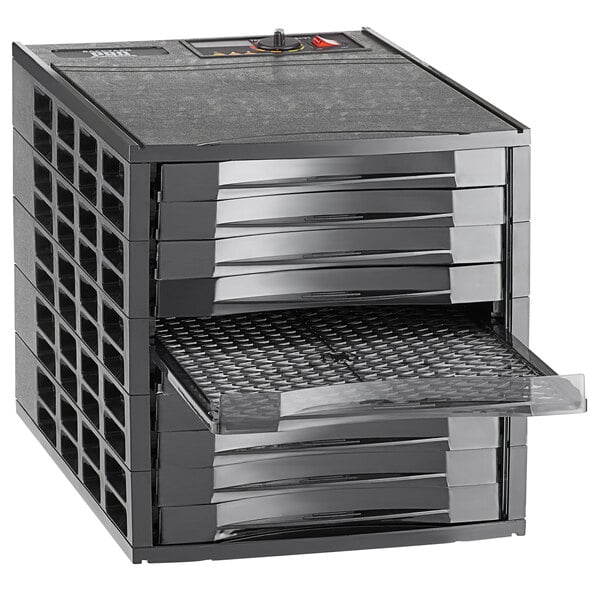 A black rectangular Backyard Pro food dehydrator tray with several trays inside.