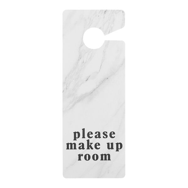 A white marble-patterned hotel door sign with the text 'please make up room' printed in black letters.