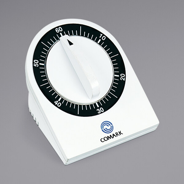A close-up of a Comark mechanical kitchen timer with a white background and black numbers.