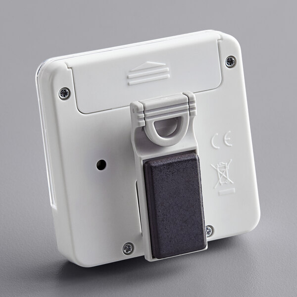 A white rectangular Comark kitchen timer with a black button.