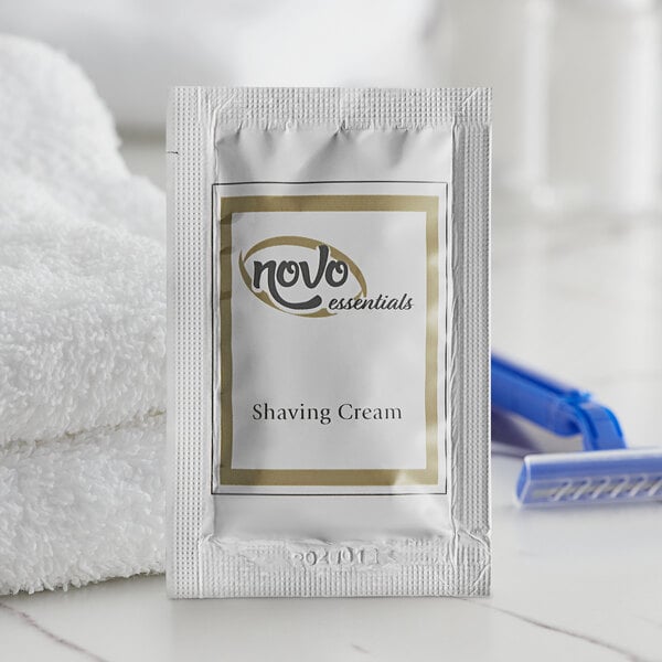 A white Novo Essentials shave cream packet on a white towel.