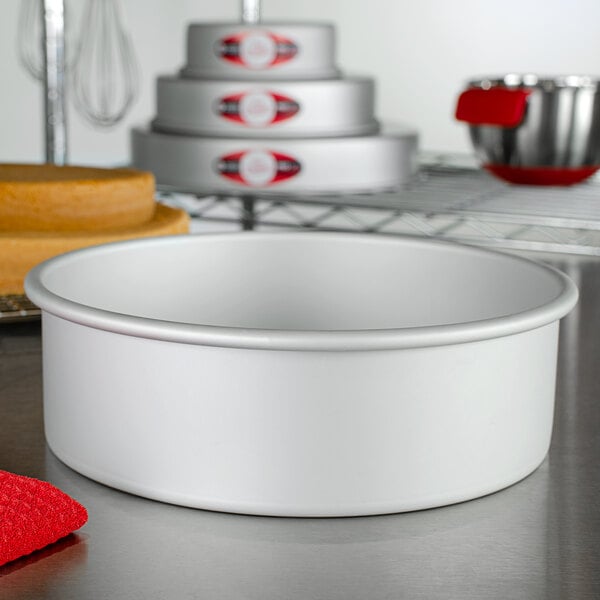 A white Fat Daddio's round cake pan on a counter.