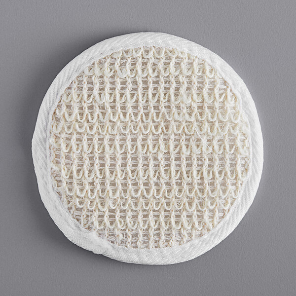 A white round Novo Essentials bath loofah with a woven surface.