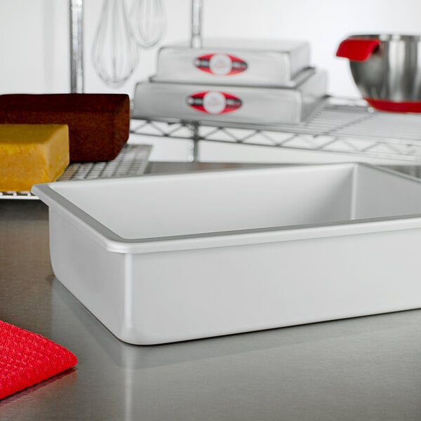 A white rectangular Fat Daddio's cake pan on a counter.