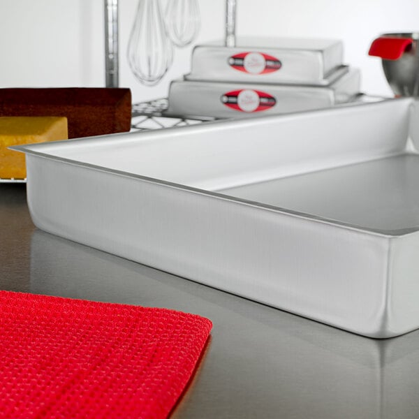 A Fat Daddio's rectangular cake pan on a white counter.