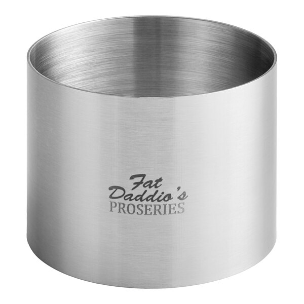 A stainless steel round cake/food ring mold with a logo on it.