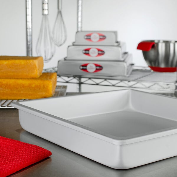 A white square Fat Daddio's cake pan on a counter.