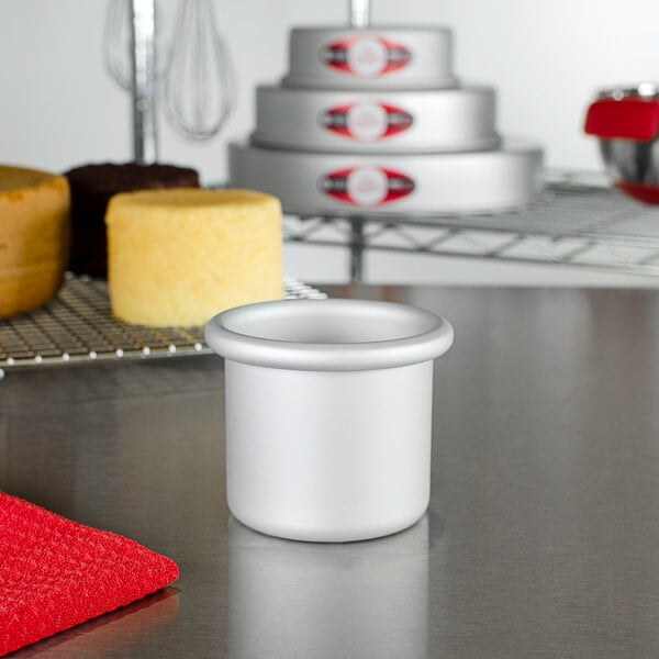 A Fat Daddio's round anodized aluminum mini cake pan on a table.