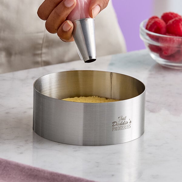 A stainless steel round cake and food ring mold measuring 5 inches by 2 inches.
