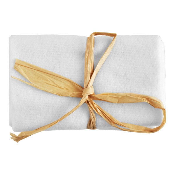 A white shoe mitt tied with a natural-colored ribbon.