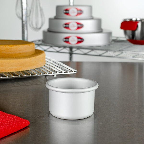 A Fat Daddio's mini round cake pan on a table.