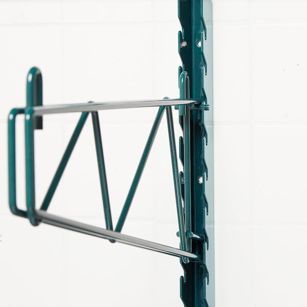 A Metroseal 3 green metal SmartWall shelf on a wall.