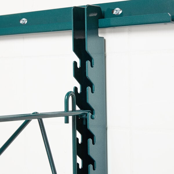 A Metroseal 3 metal shelf with two green metal hooks.